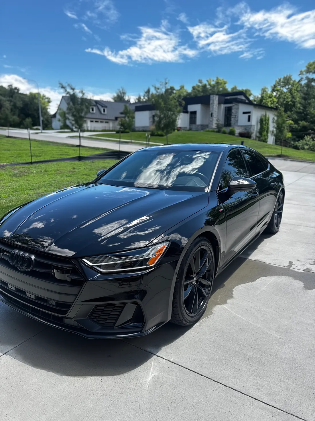 Freshly detailed black Audi A7 with a deep gloss finish, parked in an Omaha driveway